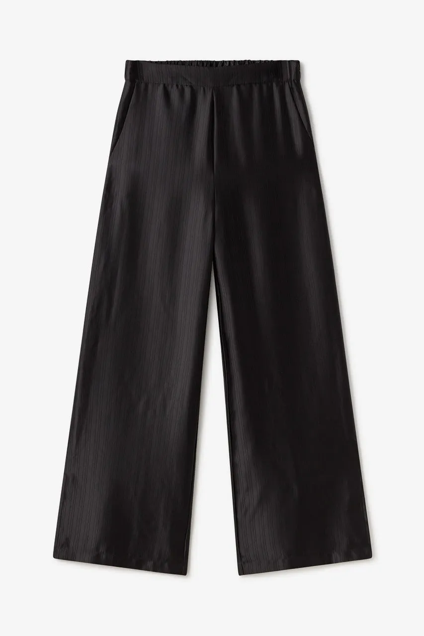 Flowy black satin palazzo trousers by NKN